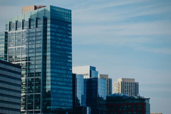 Blue glass office towers rise over a downtown business district.