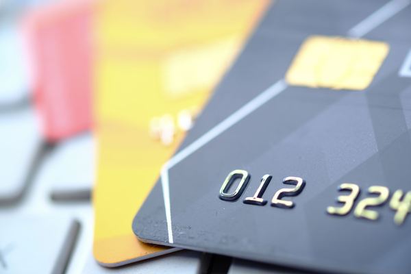 Close-up of the embossed numbers and chip on a stack of credit cards.