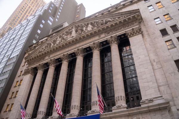 The columned facade of a stock exchange building on Wall Street.