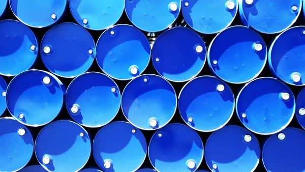 Rows of blue steel drums seen end-on, packed tightly together.