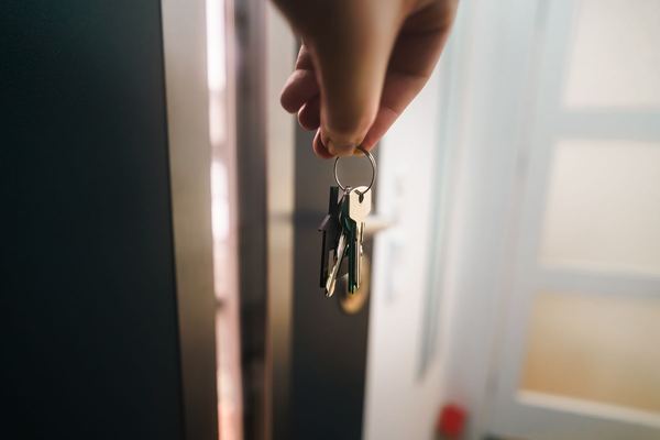 Keys hanging from the lock of a front door