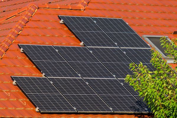 Solar panels mounted on an orange clay tile roof