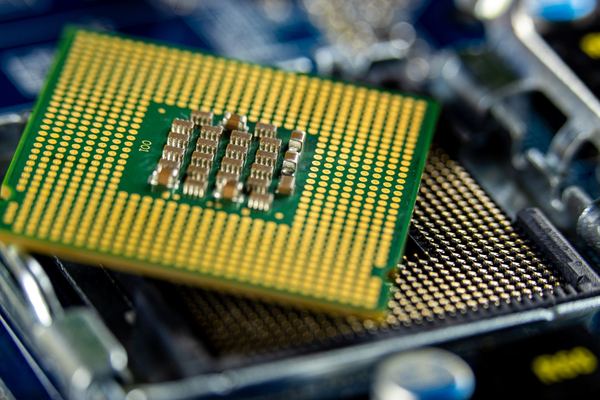 Computer processor resting above its socket on a motherboard