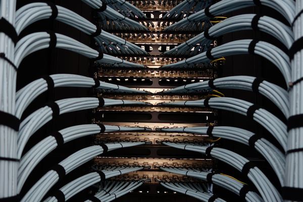 Neatly bundled network cables running into a server rack